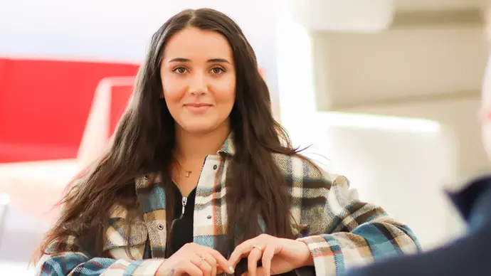 En tjej i fokus med vit och röd bakgrund